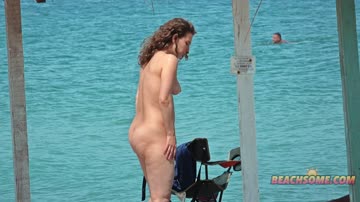 Naked ginger girl at a beach